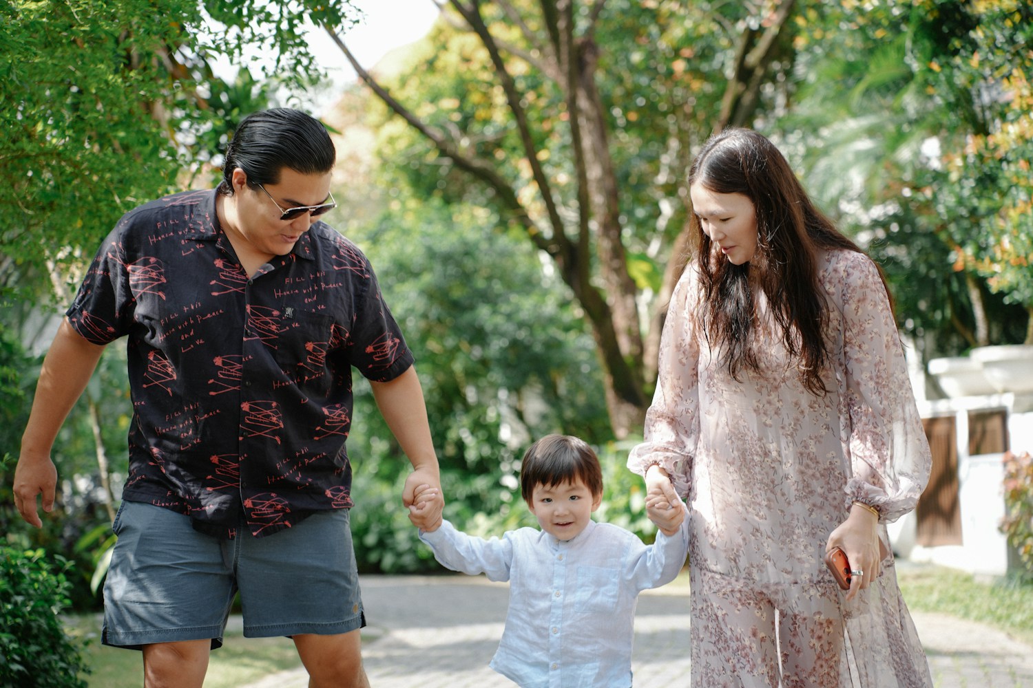 Parents enjoying a walk in the park with their child